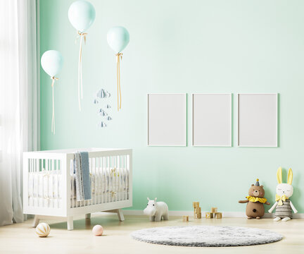 Blank poster frames mock up on green wall in nursery room interior background with baby bedding, soft toys, balloons, 3d rendering