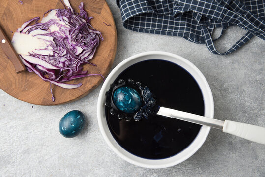 the process of painting Easter eggs with red cabbage. top view