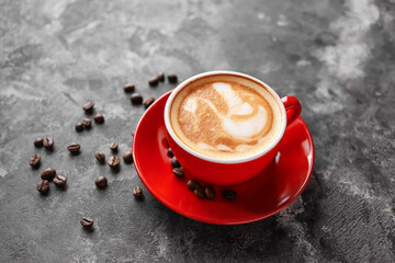 Cup of coffee with latte art on grunge background