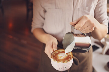 Fototapeta na wymiar Barista making latte in cafe