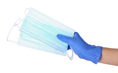 Female hand in protective glove with medical masks on white background