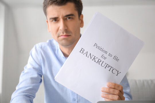 Stressed man with petition to file for bankruptcy at home