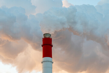 Air pollution by harmful emissions. Pipes with smoke on the background of a blue sk