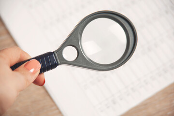 woman hand magnifier with document