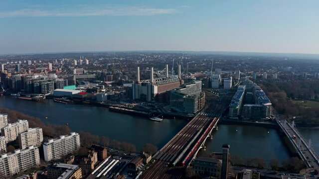 High circling drone shot around Battersea Power station on a beautiful sunny day