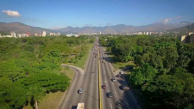 From the top view of a highway in Valencia, Carabobo, Venezuela, next to a green park
