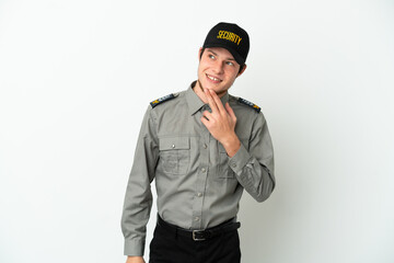 Young Russian security man isolated on white background looking up while smiling