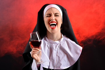 Naughty nun with glass of wine on dark background