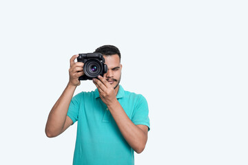man with a professional DSLR camera, showing thumbs up, checking  photos, showing the camera, operating the camera, with a blank white plate