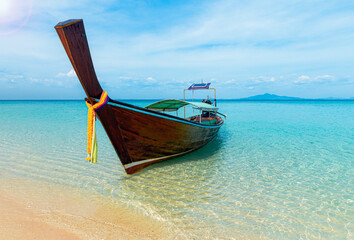 Thai traditional wooden longtail boat and beautiful sand beach at Koh Phi Phi island in Krabi province. Ao Nang, Thailand.

