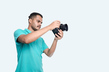Fototapeta na wymiar man with a professional DSLR camera, showing thumbs up, checking photos, showing the camera, operating the camera, with a blank white plate