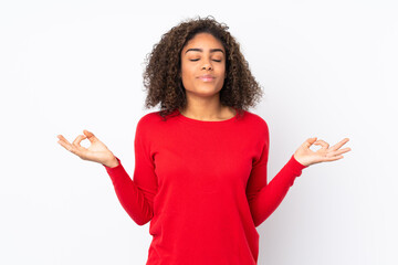 Young African American woman isolated on background in zen pose