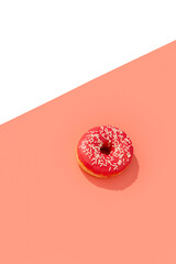 Tasty pink donut on creative background with deep long shadow