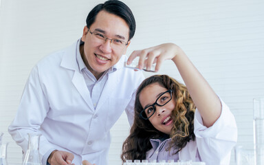 Fototapeta premium Teacher teaching science to caucasian teen girl at school