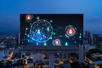 Fototapeta na wymiar Glowing Social media icons on billboard over night panoramic city view of Kuala Lumpur, Malaysia, Asia. The concept of networking and establishing new connections between people and businesses in KL