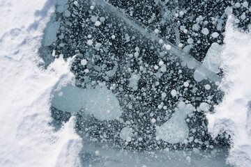 bubbles in blue transparent ice on the lake