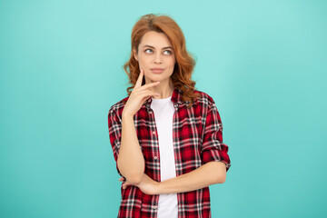 thinking redhead woman with curly hair in checkered casual shirt, fashion