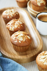 Close up of banana muffin almond in a wooden plate with a cup of coffee, an optional vegan dessert for a healthy diet  