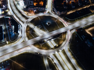 Huge roundabout, bridge and roads intersection at night - aerial shot in Vilnius
