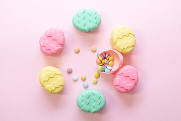 Minimalism concept of Easter candies on pink background.  Flat lay. Space for text. 