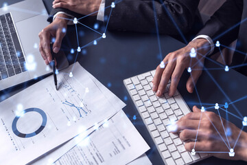 Two HR specialists man and woman analyzing the market of alumni to boost the intern program at international consulting company. Hiring new talented officers. Social media hologram icons.