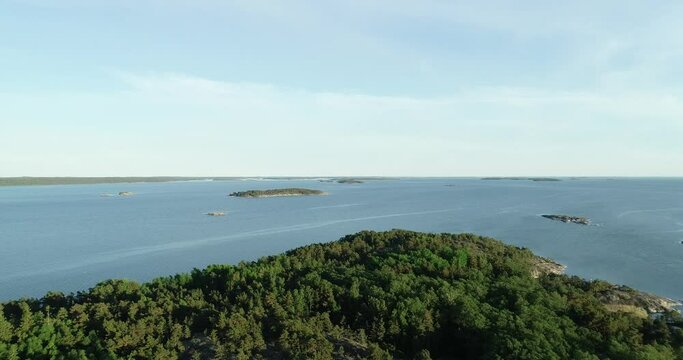 Aerial view of beautiful islands with green trees and rocks on the baltic sea at sunset. Colorful landscape with islands. Top view. Saaristomeri, Finland.