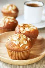 Close up of banana muffin almond in a wooden plate with a cup of coffee, in background an optional vegan dessert for a healthy low carb diet  
