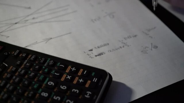 Teen doing science and math homework and online school at home during pandemic - online high school remote learning