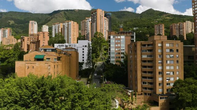 Establishing Aerial Shot of Affluent South American Neighborhood with Mountains in Background.