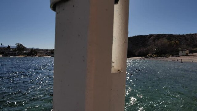Sunny Colorado river beachfront in Laughlin, Nevada USA. Slow motion dolly view