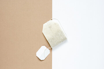 top view of dried tea bag placed on white paper and brown paper, copy space concept.