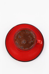 Coffee in a red mug on a white background