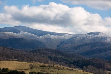 Dramatic view of snow covered Appalachian mountains under blue sky in Virginia.