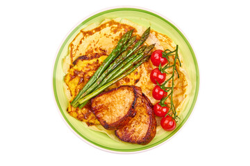 Roasted juicy pork steaks with asparagus, isolated on white background. High resolution image