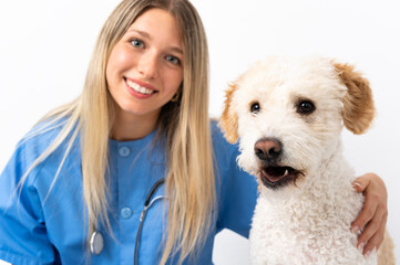 Young veterinarian woman with dog sitting on the floor