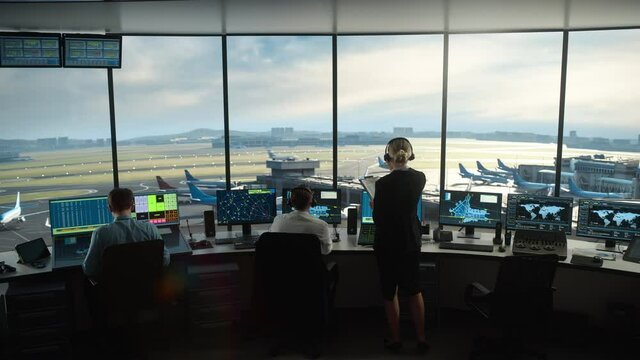 Diverse Air Traffic Control Team Working in a Modern Airport Tower. Office Room is Full of Desktop Computer Displays with Navigation Screens, Airplane Flight Radar Data for Controllers.