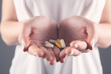 closeup woman hand holding pills