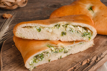 Appetizing fresh culinary pastry - pies with different fillings on a wooden