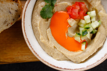 A bowl of creamy hummus with fresh vegetables