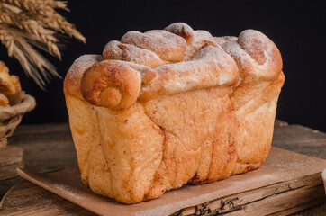 Beautiful loaf of white bread on wooden background