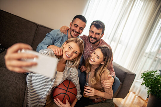 Friends watching basketball game