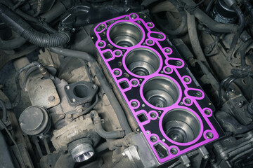 Cylinder head gasket replacement. Repair of a turbocharged diesel engine in a car workshop.