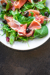 salad jamon prosciutto green leaves mix lettuce olives vegetables meat snack healthy meal top view copy space food background rustic image