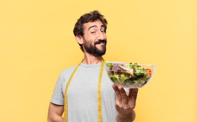 young crazy bearded man dieting happy expression and holding a salad