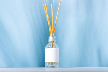 Incense sticks for the home. Blue background with plant shadows and aroma diffuser. Eco-friendly home fragrance concept