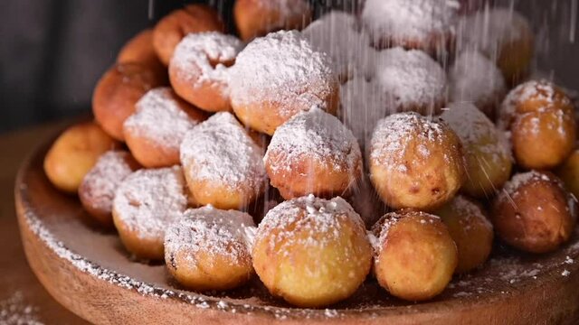 Baked castagnole with powdered sugar. Street food, round biscuits with sugar for the carnival of Venice. Traditional sweet pastries during the carnival period in italy. Copy space. 