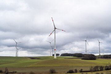 Fototapeta na wymiar Wind turbines in the countryside with cloudy sky 