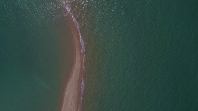 4k overhead moving forward clip over a peninsula on  the tropical beach of Epanomi, Halkidiki, Greece