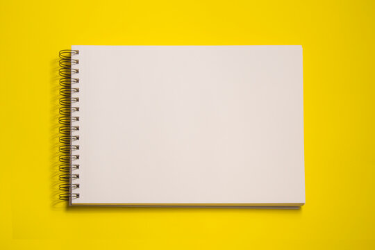 white sheets sketch pad, isolated on yellow background