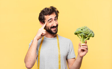 young crazy bearded man dieting thinking expression and holding a cabbage